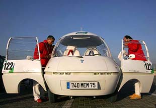 Participants board their electric-powered Courrges La Bulle car at the start of the Challenge Bibendum Rally, a clean vehicle event, in Shanghai 
