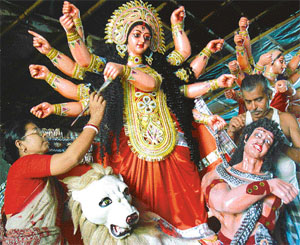 Ms Nomita Adhikary and her husband Goverdhan give final touches to an idol of Goddess Durga at Chandigarhs Kali Bari on Wednesday. The couple has been preparing these idols in Chandigarh for the past 26 years. The Durga Puja celebrations are scheduled to commence next Tuesday. 