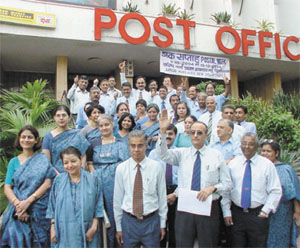 NEW LOOK: Senior officers of the postal department in their new uniform in front of the main post office in the Capital on Wednesday. 
