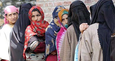 Kashmiri women wait for their turn to cast their vote outside a polling station