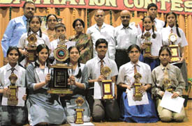 Winners of Reena-Simmi Memorial Inter-School declamation contest with trophies at K VM School