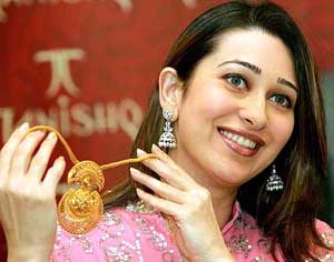 Bollywood actress Karisma Kapoor displays a necklace during the launch of a new range of Tanishq jewellery in New Delhi