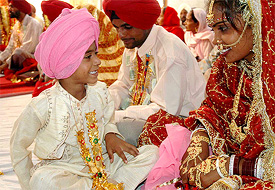 A boy shares a light moment with his bhabi during a mass marriage ceremony in Mohali on Thursday. 