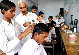 Students of Govt High School, Sector 25, learn the skills of hair cutting from a trainer, Mr Fakir Chand, under a new project to teach vocational skills to students. 