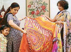 The elegance of hand painted sarees on display.
