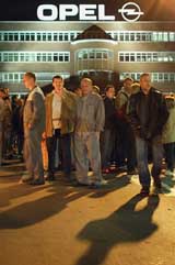 Workers of General Motors German unit Adam Opel AG stand in front of their factory in Bochum