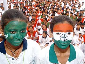 Two schoolgirls paint their faces to facilitate Indo-Pak friendship