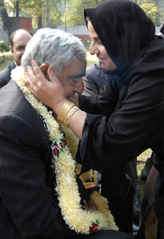 A supporter of Jammu Kashmir Peoples Democratic Party kisses the forehead of Chief Minister Mufti Mohammad Sayeed in Srinagar on Saturday.