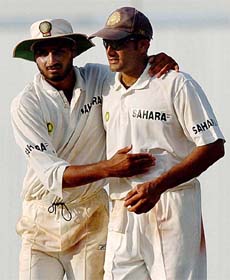 ndia's ace spinner Anil Kumble being congratulated by team-mate Harbhajan Singh