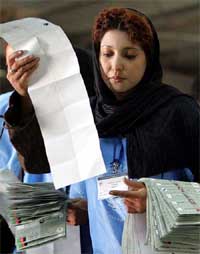 An Afghan election worker sorts ballot papers at a counting centre in Kabul on Sunday. 