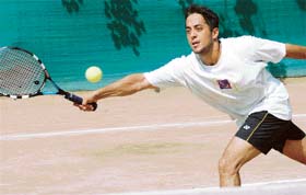 Sunny Sapra of Jalandhar returns a shot against Vikas of Chandigarh during a quarterfinal of the Head Total Tennis Championship in Chandigarh
