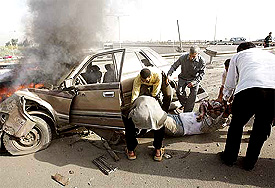 Iraqis drag the body of a man