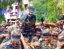 STF personnel lift their chief K. Vijaykumar to celebrate their success
