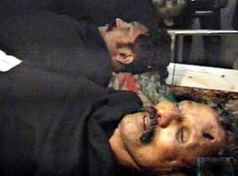 A TV image of the dead bodies of forest brigand Veerappan and his associate