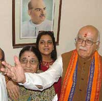 Newly appointed BJP President L.K. Advani with his wife Kamla and daughter Pratibha arrives to take charge at the party headquarters in New Delhi on Tuesday.