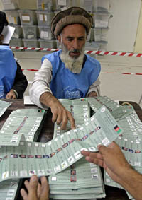 An Afghan election worker sorts ballot papers