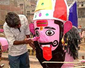 An artist gives finishing touches to Ravana’s effigy