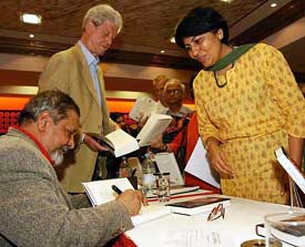 Nobel laureate Sir V.S. Naipaul signs his autograph on his new book "Magic Seeds" at a bookstore in Bangalore 