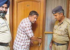 Enforcement staff of the Chandigarh Administration seal a guest house in Sector 7 in Chandigarh