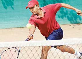 Tushar Sharma returns a shot during a semi-final match against Arvind Sharma
