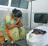 Veerappans wife in tears in the ambulance while being transported from the hospital after her husbands post mortem.