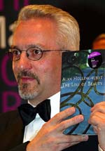 Alan Hollinghurst, winner of the 2004 Man Booker Prize for fiction, poses for the cameras after getting the award in London late on Tuesday. 