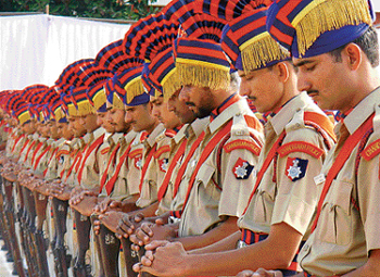 Chandigarh Police personnel reverse arms during a parade to mark the Police Commemoration Day in Chandigarh on Thursday