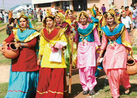 Girls in brightly coloured attire arrive to participate in the youth festival.
