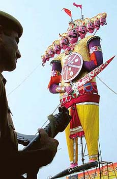 A policeman on guard near the effigy of Ravana at Subhash Maidan near the Red Fort in Old Delhi area