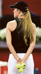 A model holds tennis balls prior the start of play between Spains Juan Carlos Ferrero and Perus Luis Horna at the Madrid Masters tennis tournament in Madrid
