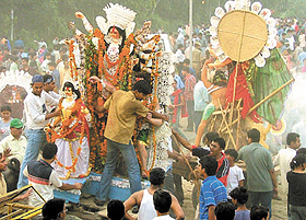 A Durga idol being carried by devotees for visarjan in Yamuna at Geeta Ghat in the Capital on Saturday.