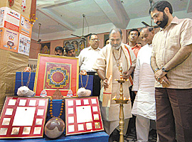 Mahant Surinder Nath Avdoot of Kalika Peeth lighting the lamp during the inauguration of Stone & Rudraksh exhibition at Kalka Temple in the Capital on Sunday.