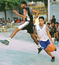 A player from Police DAV School, Amritsar, dodges a DAV School, Sector 8, player during a semifinal of the Rao Jai Singh Memorial Basketball Tournament