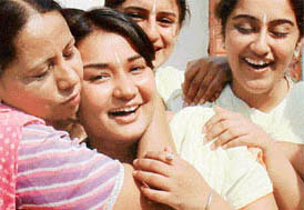 A teacher embraces a member of her college team after hearing the result of the group bhajan/shabad competition held on the inaugural day of the six-day Panjab University Zonal Youth and Heritage Festival