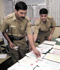 The Delhi Police display the stolen drafts, cheques and packets containing cash and valuables