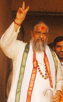 Chandraswami shows the victory sign as he comes out of Tis Hazari Court in New Delhi on Monday.