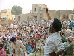 BKU (Ekta) activists hold a rally at Chathewala village on Monday to oppose the proposed auction of a piece of land. 