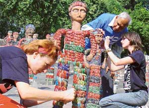 RESTORING ART: Members of the Nek Chand Foundation, UK, repair sculptures under the supervision of Nek Chand at the Rock Garden in Chandigarh on Tuesday.