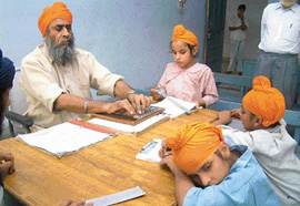 A blind teacher in a mathematics class for blind students at the orphanage