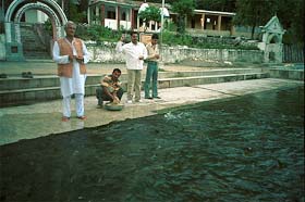 Devotees offer wheat flour balls to fish at Renuka