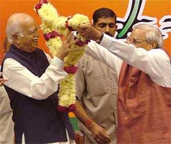 Mr Atal Bihari Vajpayee welecomes Mr L.K. Advani with a garland at the BJP National Council meeting at Talkatora Stadium in Delhi on Wednesday. 