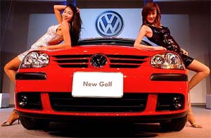 South Korean models pose with Volkswagens New Golf 2.0 FSI during a press unveiling in Seoul