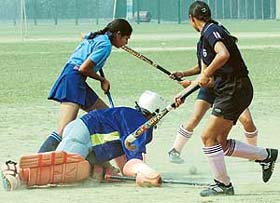Players of GCW, Ludhiana, and GGSK College, Chandigarh, in action during an inter-college hockey match at Panjab University