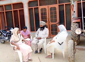 Ramandeep’s father Gurcharan Singh with his family members at his home in Fatehgarh Korotana village near Moga on Thursday.