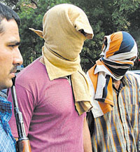 Pramod Kumar and Ranjit Kumar Mishra, who were arrested on the charge of extortion by Delhi Police Crime Branch in the Capital on Friday. 
