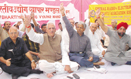 Up in Arms: Traders under the banner of Bhartiya Udyog Vyapar Mandal sitting on dharna against the proposed VAT system at Rajghat in the Capital on Friday.