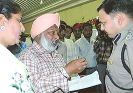 Mr Parag Jain, DIG, Ludhiana Range, interacts with a complainant at a special camp in Mohali on Sturday. 