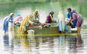 Women walk long distances to ponds for washing clothes
