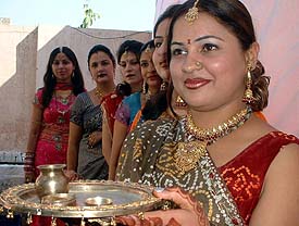 Decked up women await the moonrise to break Karva Chauth fast for the long life of their husbands