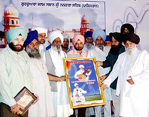 Representatives of NRI devotees felicitate Bhai Mardanas descendant Bhai Lalji in Moga.